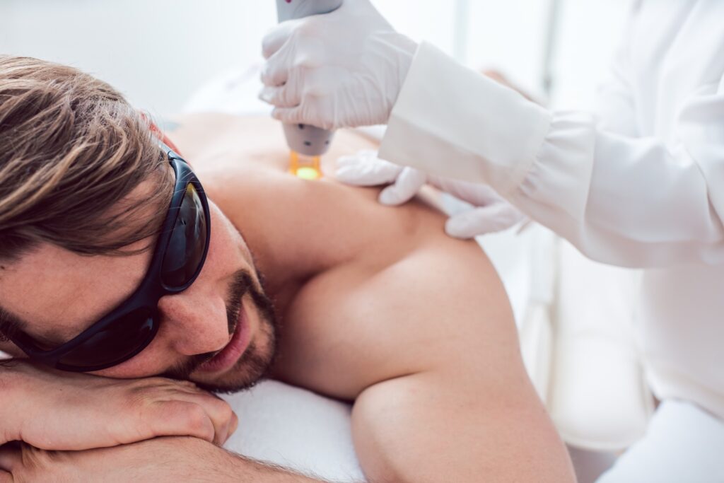 Man under treatment in a hair removal studio
